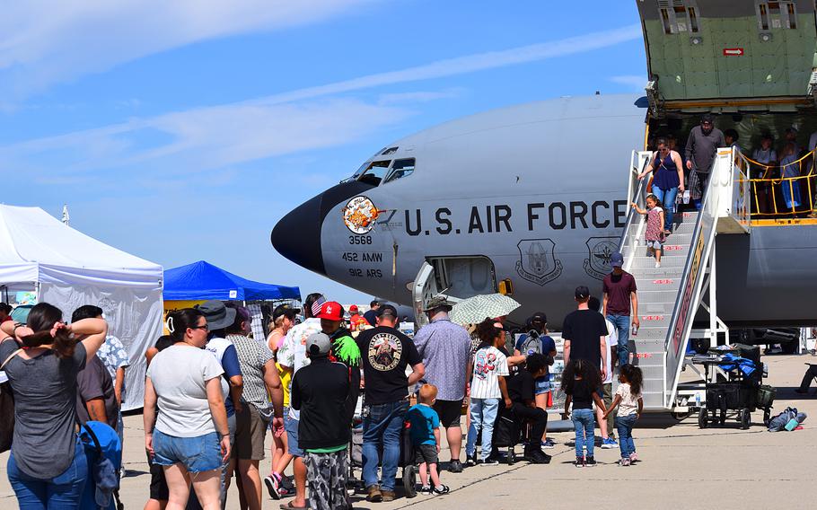 Air show enthusiasts stand in line to participate in a tour of the KC-135 Stratotanker