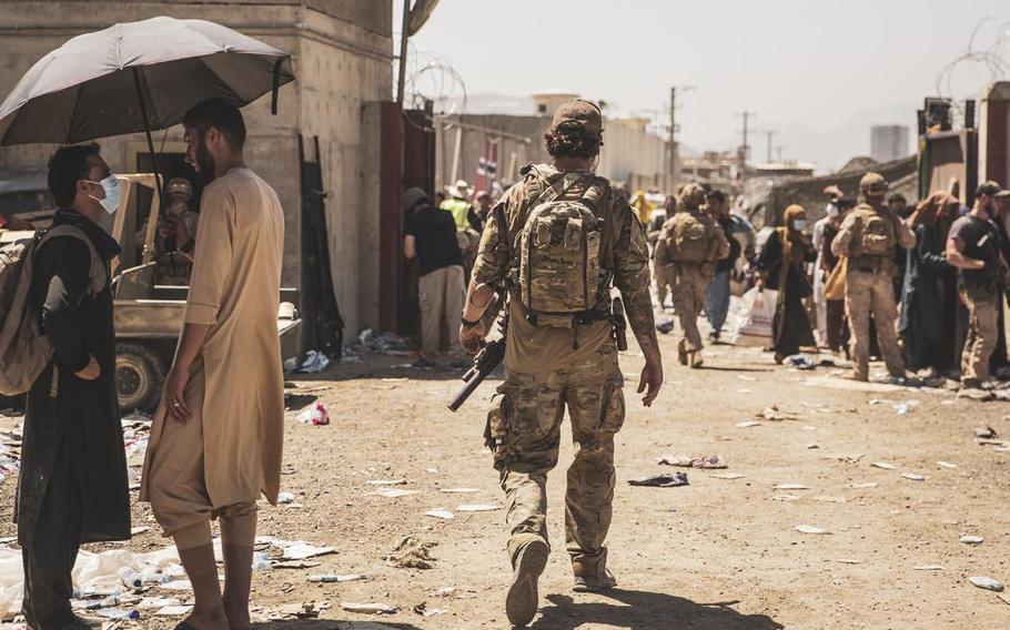 A Canadian coalition forces member walks through an evacuation control checkpoint during an evacuation at Hamid Karzai International Airport, in Kabul, on August 24, 2021. 