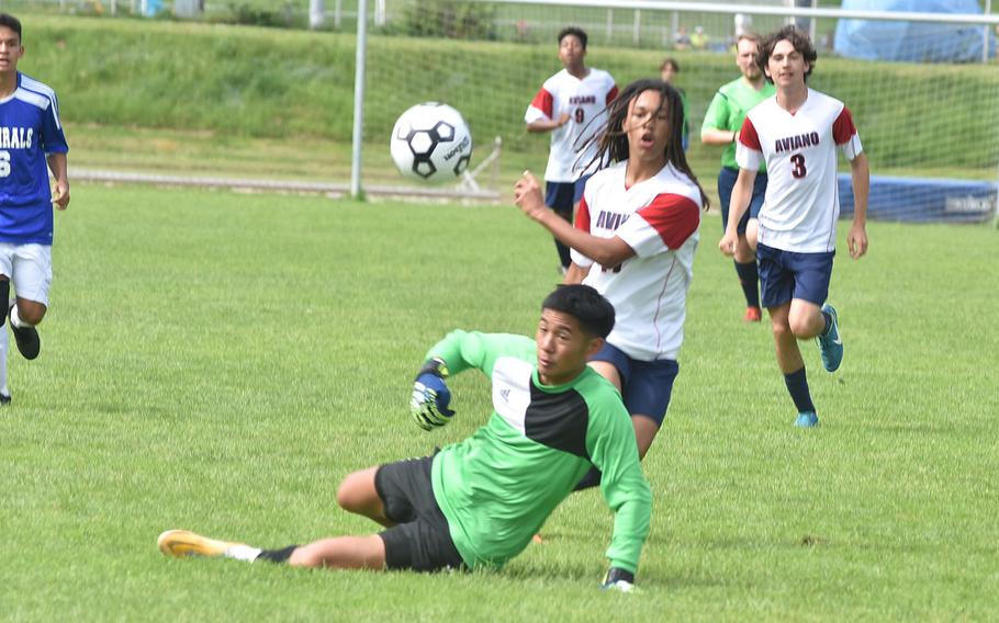 Rota goalkeeper Nathan Alindog breaks up a run on goal by Aviano's Andrew Walker at the DODEA-Europe boys Division II soccer tournament at Landstuhl, Germany.