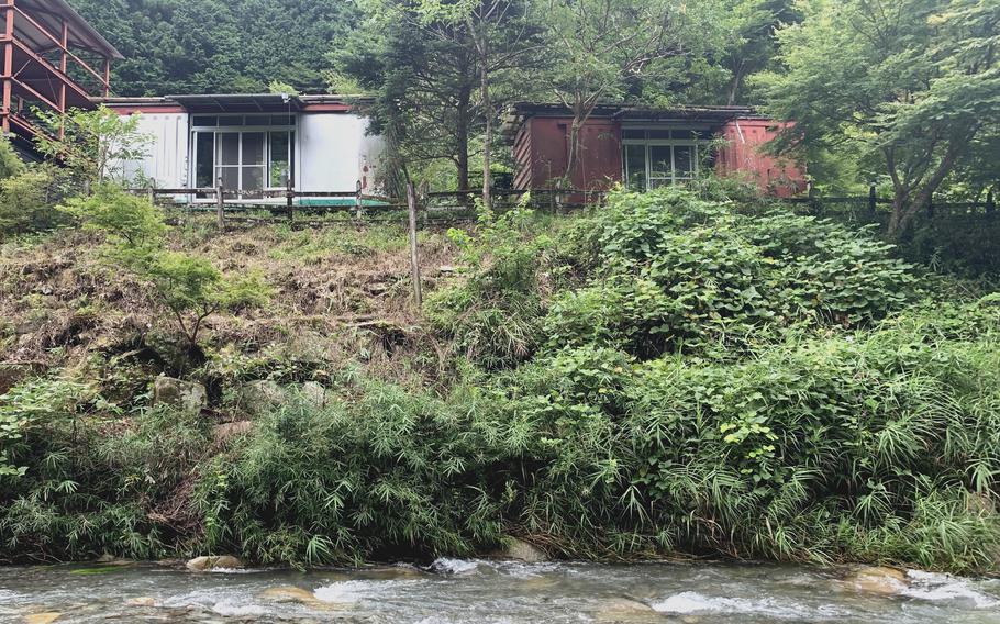 Converted railroad cars provide comfortable rooms at the Earth Hostel along the Kuro River near Nikko, Japan.