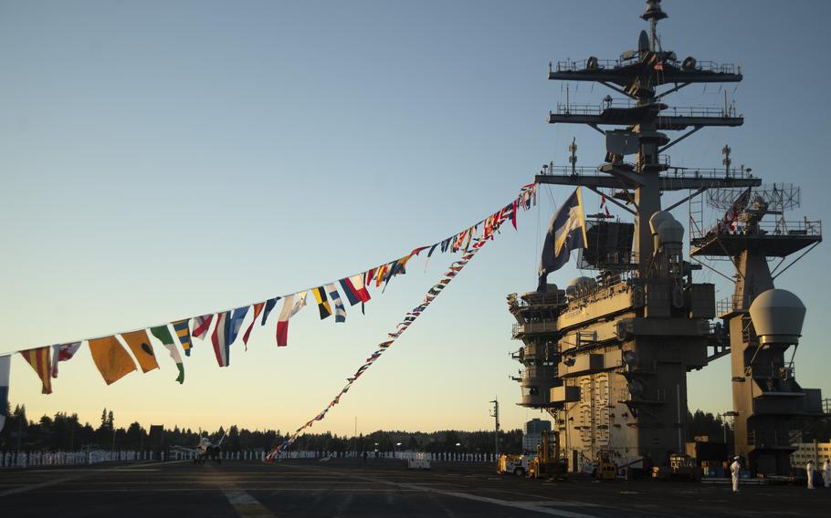 Sailors line the rails on the flight deck of the aircraft carrier USS Nimitz on its return to homeport.