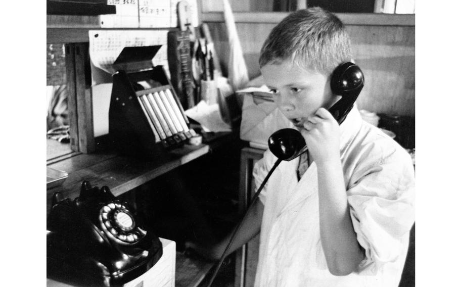 A child speaks on a telephone