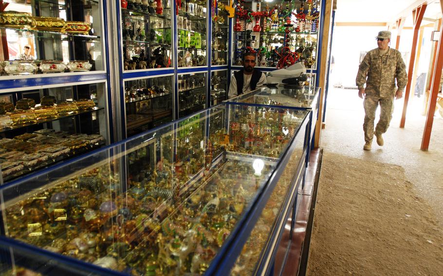 A trove of trinkets shimmer in the glass cabinets of an Army and Air Force Exchange Service shop at Bagram Airfield, Afghanistan in 2006.