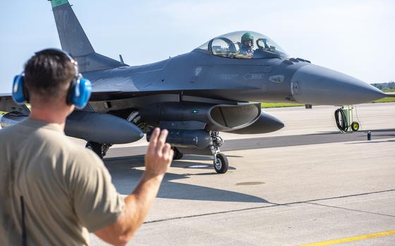 U.S. Air Force Master Sgt. Stephen Boehme, assigned to the Ohio Air National Guard 180th Fighter Wing, directs an F-16 Fighting Falcon to Volk Field on Camp Douglas, Wis., during Exercise Northern Lightning, Aug. 7, 2023.