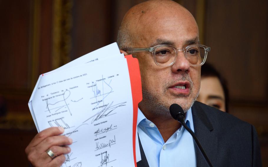 Jorge Rodriguez, president of the National Assembly, displays the document signed between the Venezuelan government and the opposition in Barbados, during a press conference in Caracas, Venezuela, on Thursday, Oct. 19, 2023.