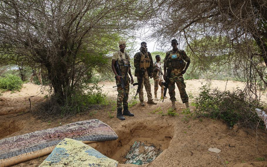 Danab and Gorgor soldiers stand near a former al-Shabab camp in Masjid Ali Guduud, an area recently taken back from al-Shabab control in Somalia. 