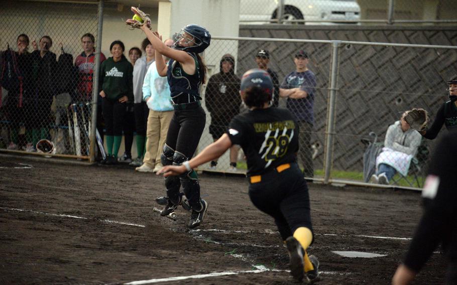 Kubasaki catcher Taylor Tobin catches a throw to the plate too late to nail Kadena baserunner Jade Wolfgang with an in-park home run during Tuesday's DODEA-Okinawa softball game. The Panthers won 4-1 and took a 3-0 season-series lead over the Dragons.