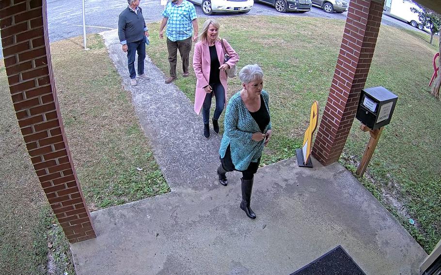 Coffee County GOP chairwoman Cathy Latham (bottom) escorts employees of SullivanStrickler, an Atlanta-based data forensics firm, into the Coffee County election office on Jan. 7, 2021. MUST CREDIT: Obtained by The Washington Post.