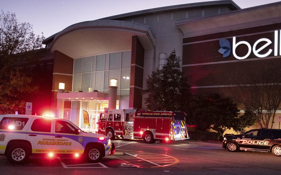Emergency vehicles congregate around the entrance to Belk at The Streets of Southpoint Mall in Durham, North Carolina, after three people were wounded in an afternoon shooting on Black Friday, Nov. 26, 2021.