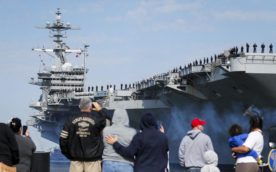 Friends and family of sailors onboard the USS George Washington watch as it departs from Naval Station Norfolk, Va., on April 25, 2024.