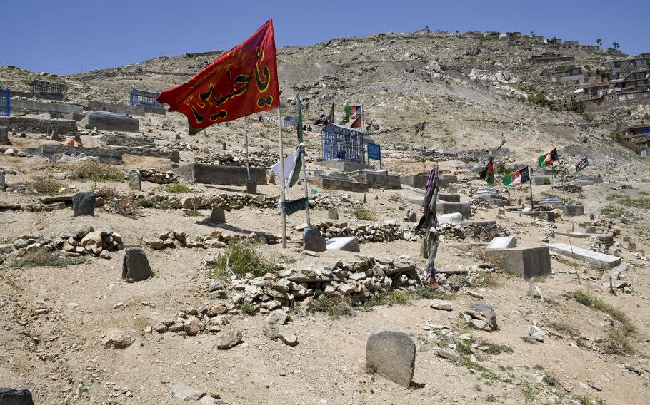 Flags fly over a cemetery in the Dasht-e-Barchi neighborhood, a majority Shiite district in the west part of Kabul, Afghanistan, where numerous funerals took place after an attack May 8, 2021, on a school there. 