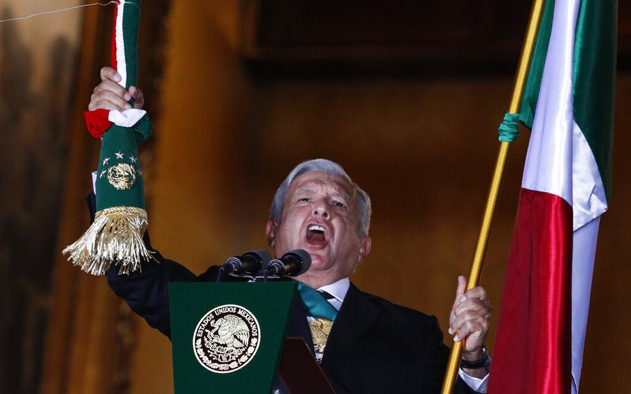 Mexican President Andres Manuel Lopez Obrador rings the bell as he gives the annual independence shout from the balcony of the National Palace to kick off Independence Day celebrations at the Zocalo in Mexico City, on Sept. 15, 2020.