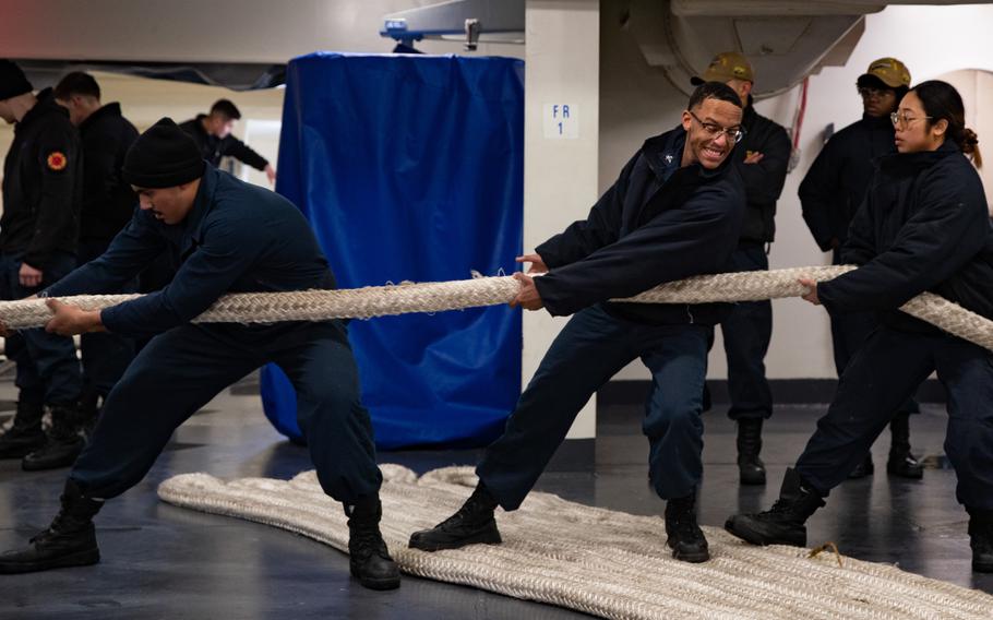 Sailors assigned to the deck department of the USS Gerald R. Ford heave around a line in the fo’c’sle during a sea-and-anchor evolution upon return from the ship’s eight-month maiden deployment, Wednesday, Jan. 17, 2024.