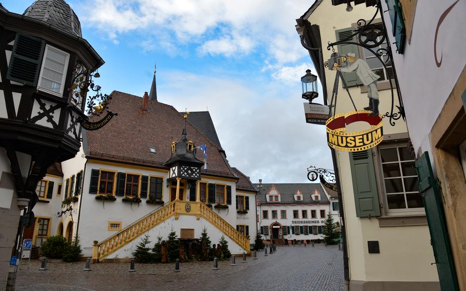 A nostalgic metal sign of a camera operator points visitors to the 3F German Film and Photo Technology Museum in Deidesheim, Germany. The museum is located in a small alley off the historic market square.