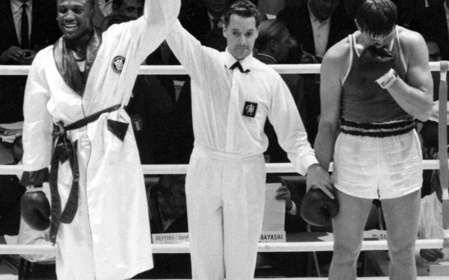 Joe Frazier of the United States is declared the winner over Vadim Yemelyanov of the Soviet Union during the heavyweight boxing semifinals at the 1964 Olympic Games in Tokyo. Frazier went on to win the gold medal. 