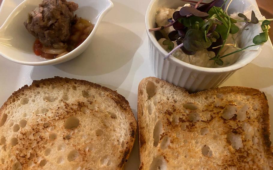 Gluten-free bread, lightly toasted and accompanied by a cheese spread and another small starter, is standard fare served to patrons at the Oelmuehle restaurant in Landstuhl, Germany. 