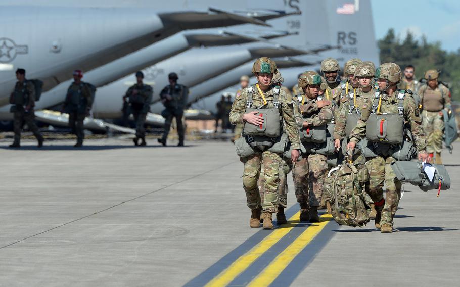 Paratroopers walk to their planes at Ramstein Air Base, Germany, on May 25, 2022. Nine C-130J Super Hercules aircraft flying together in a formation, dropped 90 paratroopers in back onto the base to mark the 37th Airlift Squadron’s 80th anniversary.