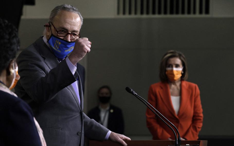U.S. Senate Majority Leader Chuck Schumer, D-N.Y., during an event on Capitol Hill in Washington on March 11, 2021. In the background is House Speaker Nancy Pelosi, D-Calif. 