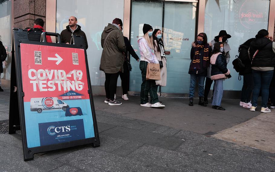Groups of people line up to get tested for COVID-19 in Times Square on Dec. 5, 2021, in New York City.