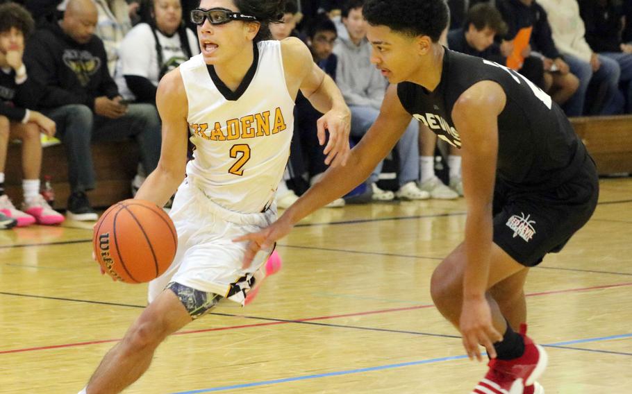 Kadena's Angel Torrado dribbles against Kinnick's Misiah Morizane. The Panthers edged the Red Devils 64-62.