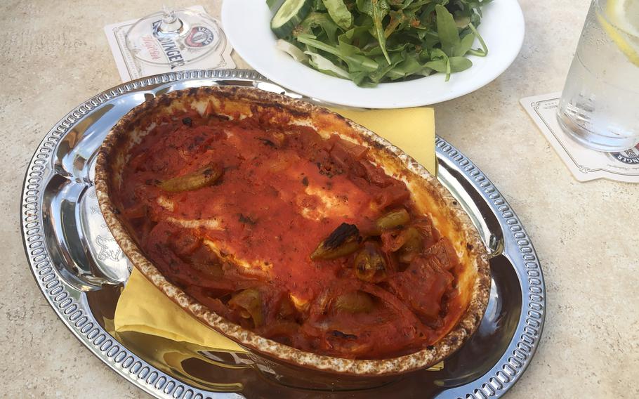 The schafskaesepfaennchen, or little sheeps cheese pan, at Piazza in Griesheim, Germany. It's a slab of feta cheese baked in a tomato sauce with peppers. At rear is the small piccola salad with lettuce, rocket, tomatoes and cucumber.