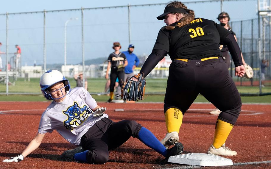 Yokota's Elena Haas slides safely into third base past infielder Jana Hurst during Friday's playoff game in the All-DODEA-Japan softball tournament. Yokota outlasted Kadena 12-8.