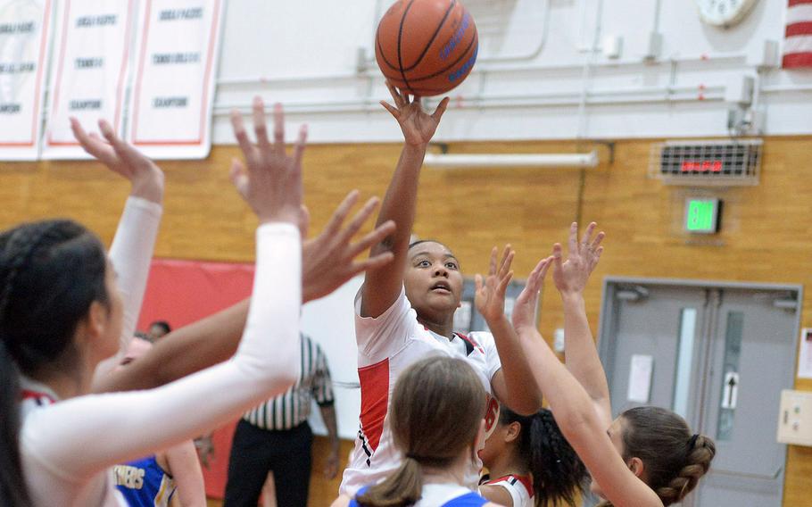 E.J. King's Moa Best puts up a shot over a sea of teammates' and Yokota defenders'  hands during Friday's DODEA-Japan girls basketball game. The Cobras won 60-39.