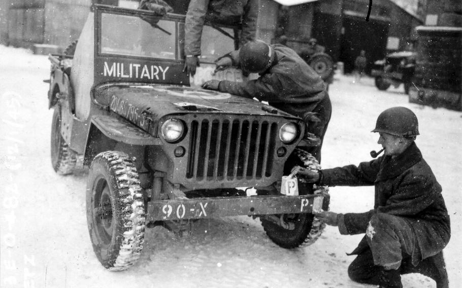 A Ghost Army Jeep gets new bumper markings for special effects.