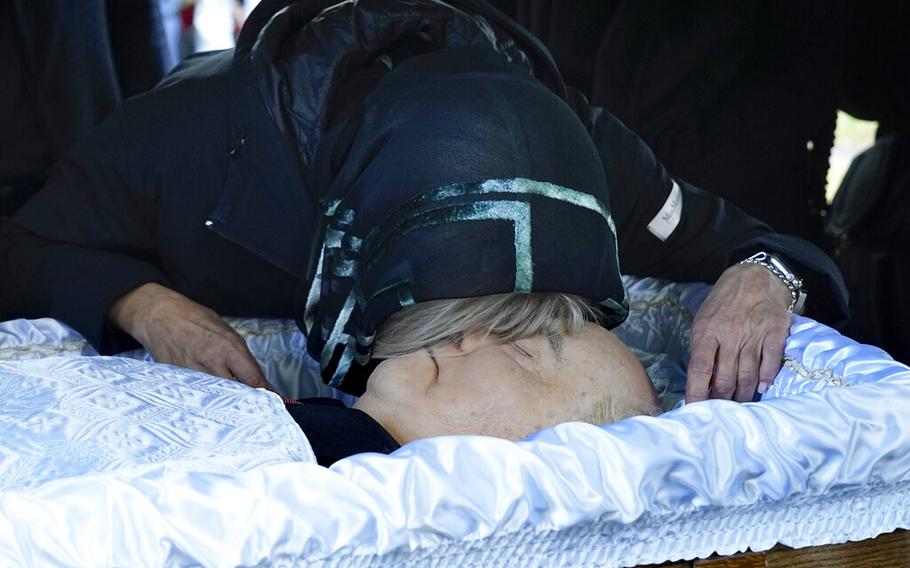 Irina Virganskaya, daughter of former Soviet Union President Mikhail Gorbachev says goodbye to him for the last time during funeral at Novodevichy Cemetery in Moscow, Russia, Saturday, Sept. 3, 2022. 