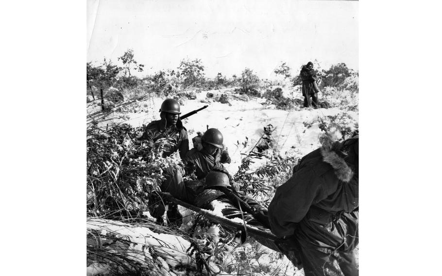 Medics carry a “wounded” soldier.