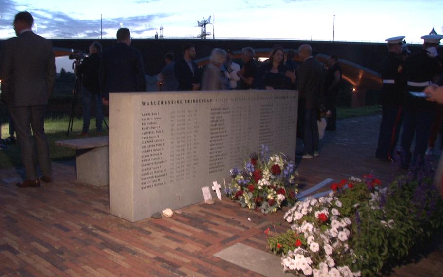 Two Marines, right, stand by the memorial in Nijmegen, the Netherlands, to 48 U.S. paratroopers who died during the Waal River crossing on Sept. 20, 1944, as part of Operation Market Garden during World War II.