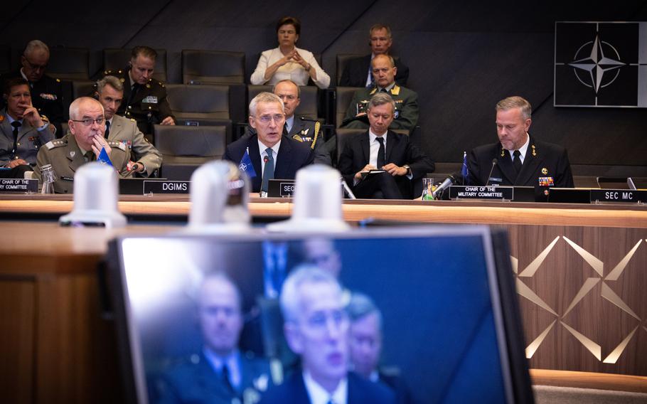 NATO Secretary-General Jens Stoltenberg, center, is flanked by alliance defense officials at NATO headquarters in Brussels on May 10, 2023. Representatives of member countries met Wednesday to fine-tune new defense strategies that are expected to transform how NATO will defend itself.