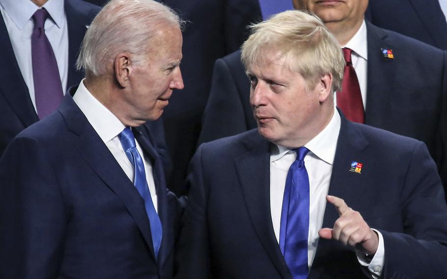 President Joe Biden and then British Prime Minister Boris Johnson speak with each other during a NATO summit in Madrid in June 2022.