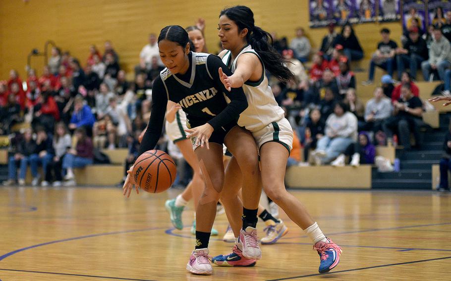 Vicenza junior Kaylah Starling fends off the defending of Naples senior Anais Navidad in pool-play action of the DODEA European Basketball Championships on Feb. 15, 2024, at Wiesbaden High School in Wiesbaden, Germany.