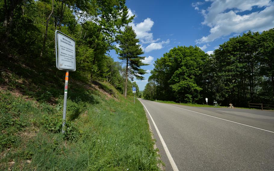 A military security area sign stands near a provisional new memorial for the German police officers Yasmin B. and Alexander K., who were shot and killed near the site on country road K22, near Ulmet, Germany, in January.