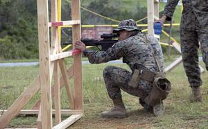 A Marine takes aim at a target 160 yards away during the Far East Marksmanship Competition at Camp Hansen, Okinawa, Dec. 7, 2022.