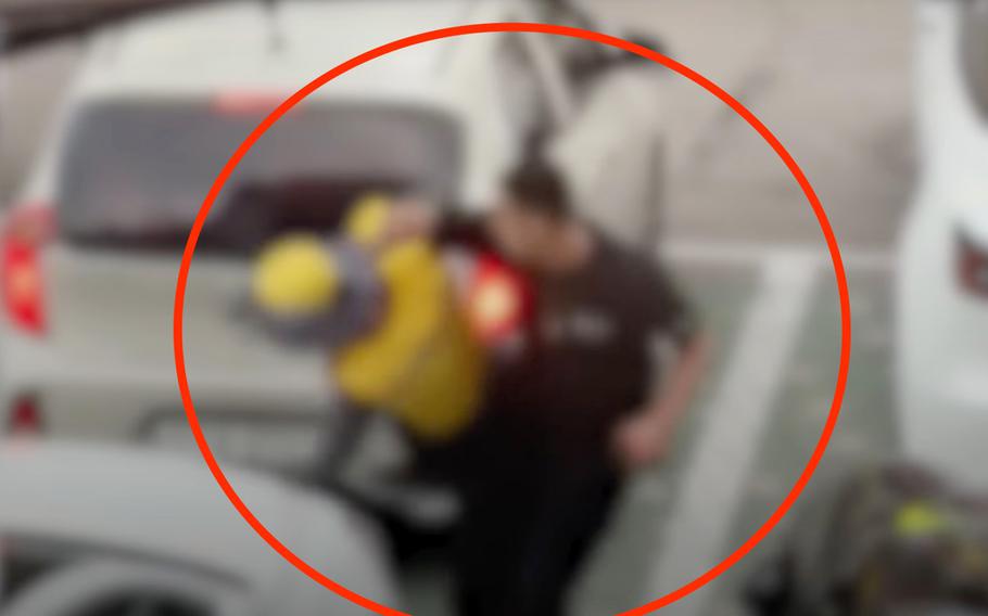 This screenshot from blurred footage obtained by South Korea’s MBC News shows an altercation between a man thought to be a U.S. Forces Korea civilian employee and a parking attendant in Seoul, South Korea, June 12, 2021. 