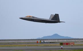 An Air Force F-22 Raptor takes off from Marine Corps Air Station Iwakuni, Japan, during Agile Combat Employment training on June 17, 2022.
