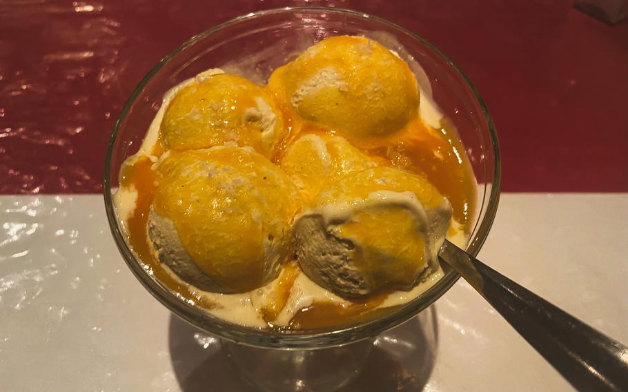 Vanilla ice cream topped with sweet mango sauce is one of three cold desserts served at Curry House in Kaiserslautern, Germany.