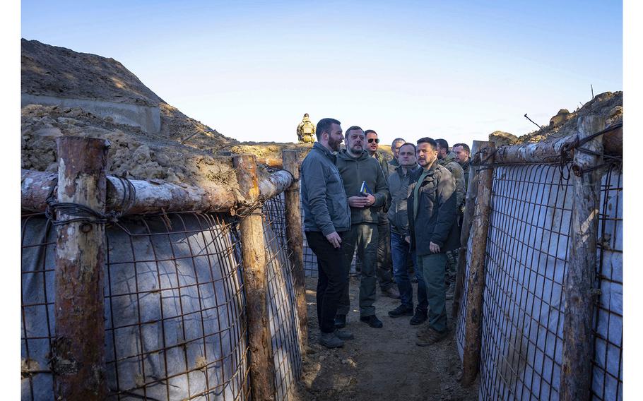 Ukrainian President Volodymyr Zelenskyy, right, inspects the fortification lines in Chernihiv region, Ukraine, on Friday, Apr. 5, 2024. 