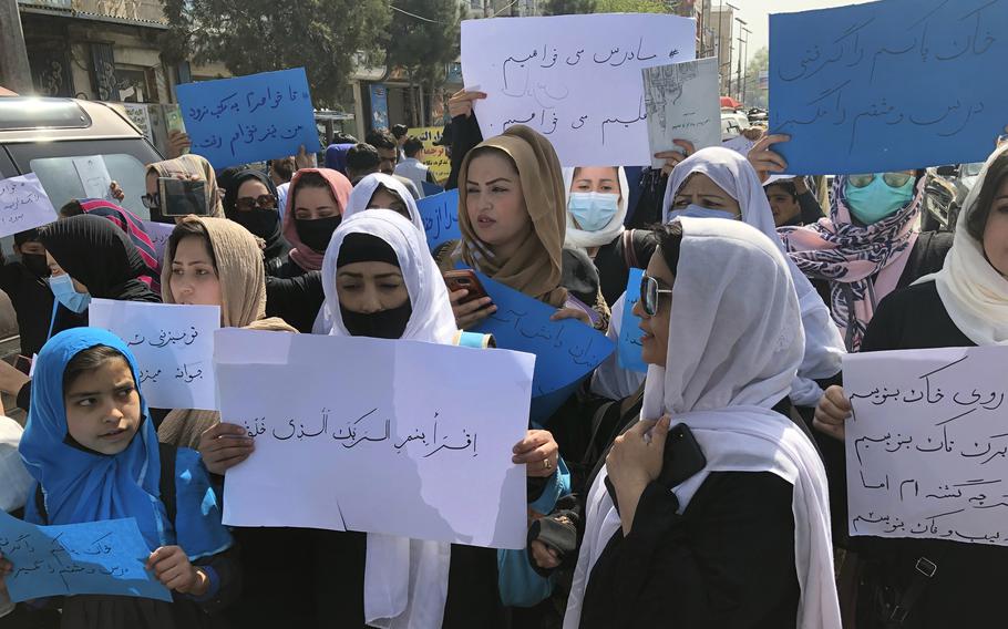 Afghan women chant and hold signs of protest during a demonstration in Kabul, Afghanistan, Saturday, March 26, 2022.