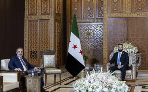 In this handout photo released by the Turkish Foreign Ministry press service, Turkish Foreign Minister Hakan Fidan, left, sits with Syria's interim President Ahmad Al-Sharaa, during their meeting in Damascus, Syria, Thursday, Aug. 7, 2025. (Turkish Foreign Ministry via AP)
