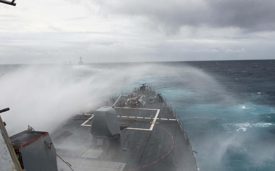 Waves crash over the bow of the guided-missile destroyer USS Arleigh Burke during a simulated straits transit exercise. 