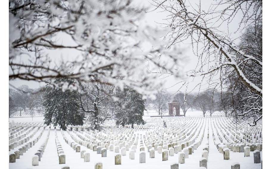 Snow falls in Section 33 of Arlington National Cemetery, Arlington, Virginia, March 21, 2018. 