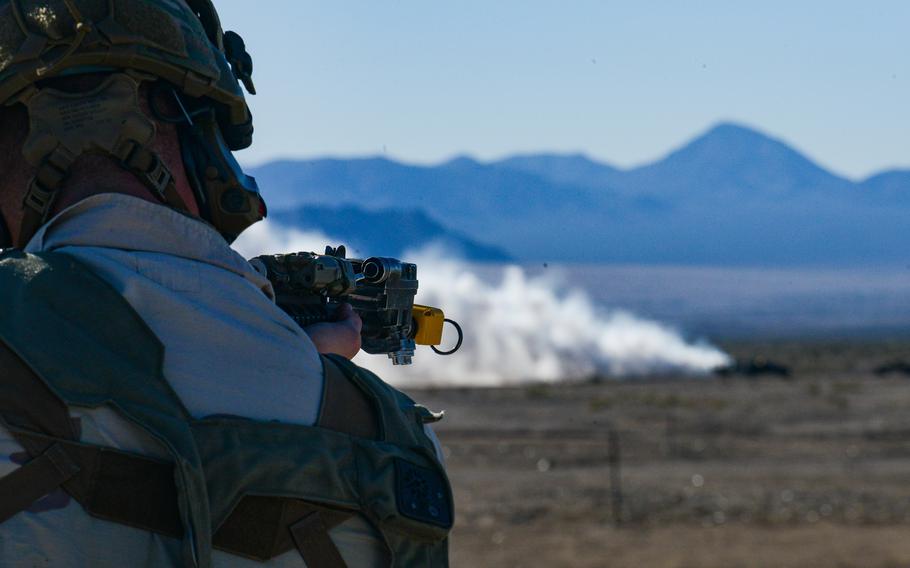 A member of the opposing force looks down his carbine as members of the 3rd Infantry Division’s 2nd Armored Brigade Combat Team approach his position during a force-on-force fight at the National Training Center at Fort Irwin, Calif., Feb. 26, 2023.