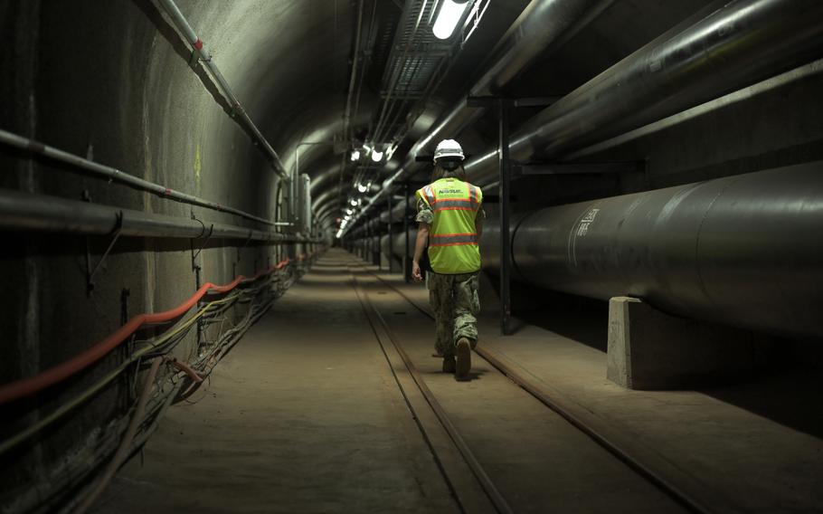 A sailor walks a portion of the 7 miles of tunnels that are part of the Red Hill Underground Fuel Storage Facility in Honolulu, Hawaii, July 17, 2020.