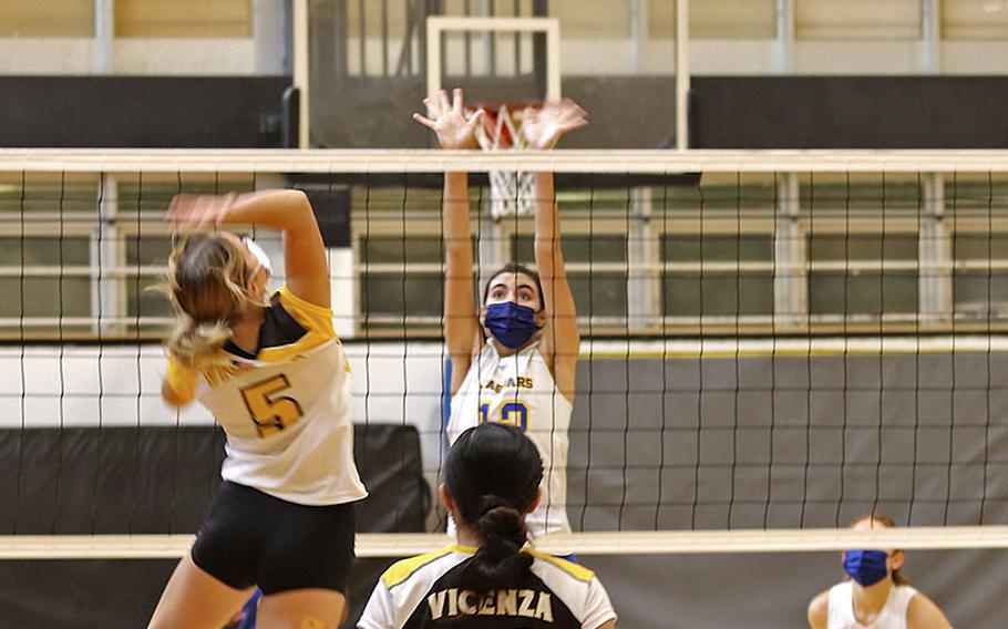 Shalom DeJardin of Vicenza attempts to spike the ball over Sigonella Jaguars' Fabiola Mercado-Rodriguez during Saturday's game at Vicenza High School. The Cougars won in straight games, 25-12, 25-12, 25-10. 