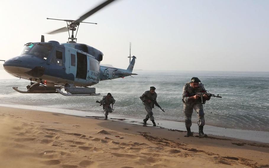 In this picture released by the Iranian Army on Saturday, Nov. 7, 2021, troops attend a maneuver in a coastal area in southeastern Iran. 