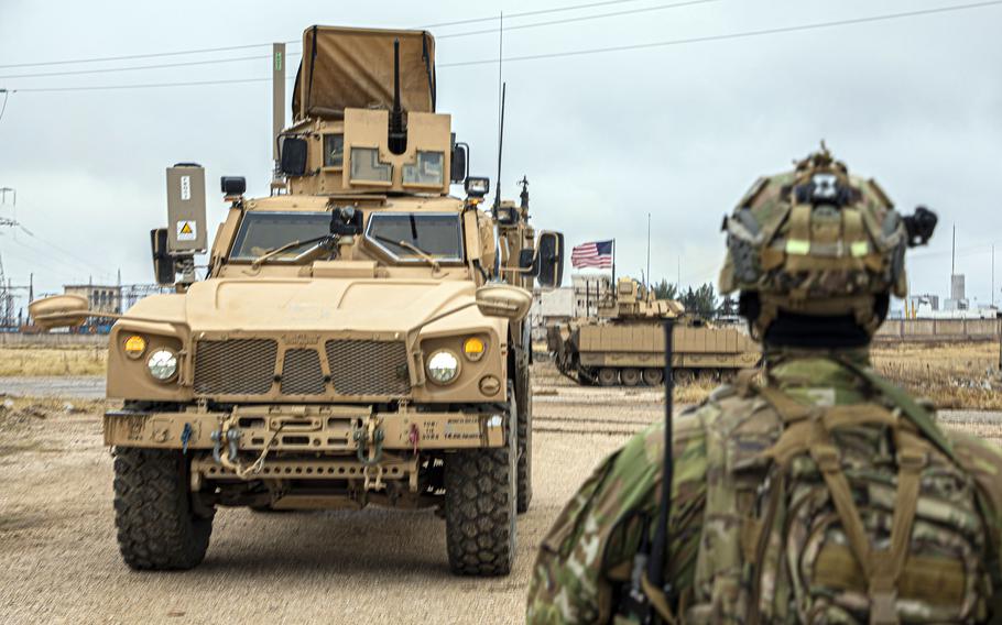 A U.S. soldier approaches an M2 Bradley Infantry Fighting Vehicle in northeastern Syria, Dec. 16, 2020.