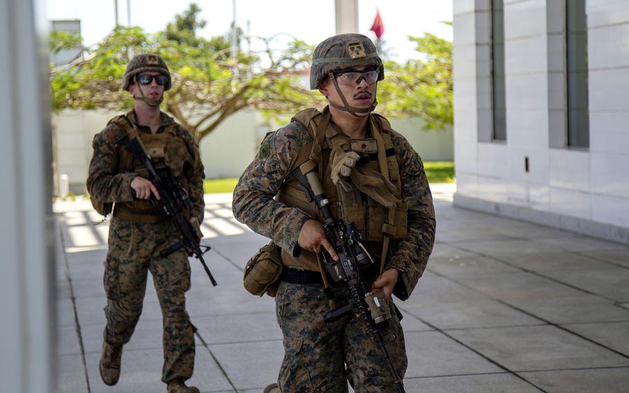 Lance Cpl. Jacob Kenneally and Lance Cpl. Jimmy Gonzalez, U.S. Marines with Anti-terrorism Security Team Europe, secure assigned sectors at the U.S. Embassy in Libreville, Gabon, during a drill, April 26, 2023. U.S. Africa Command is monitoring an apparent coup in the country.